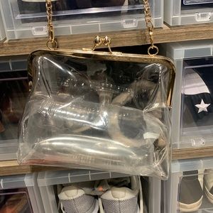 Clear purse with gold hardware. Includes a long chain that detaches